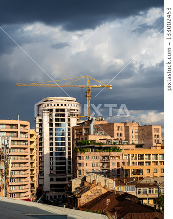 dark rainy clouds over sunlit houses in Yerevan dark rainy clouds over sunlit houses in Yerevan 133002453