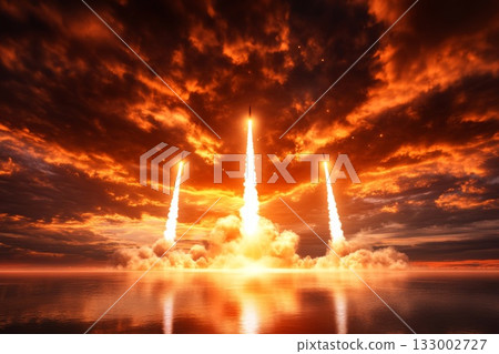 Rockets ascending into the sky with dramatic clouds and vibrant sunset reflections on water Rockets ascending into the sky with dramatic clouds and vibrant sunset reflections on water 133002727