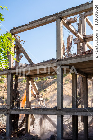 building is breaking with demolition excavator 133003024