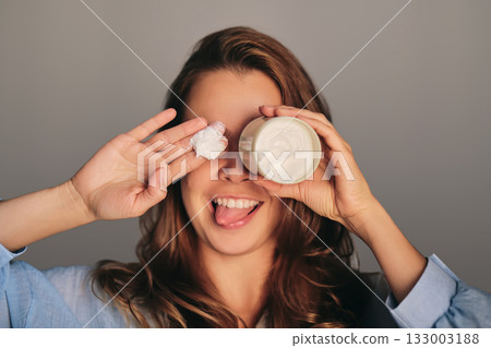 Young woman having fun with skincare cream 133003188