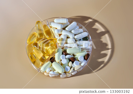 Vitamins, supplements, and pills in divided dispenser 133003192