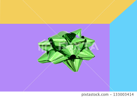 Green bow or ribbon decoration on a gift box. Green bow or ribbon decoration on a gift box. 133003414