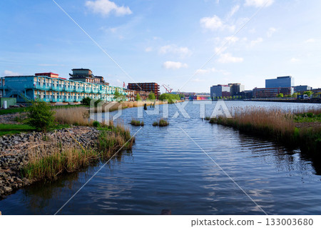 Sustainable cabins with natural materials on waterfront in Kvillepiren, Hisingen, sunny day, Gothenburg, Sweden 133003680