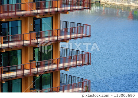 Sustainable cabins with natural materials on waterfront in Kvillepiren, Hisingen, sunny day, Gothenburg, Sweden 133003690