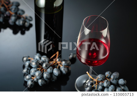 Red wine and juicy blue grapes. Red wine and juicy blue grapes. 133003713