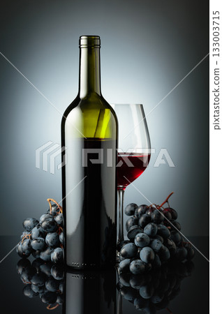 Red wine and juicy blue grapes. Red wine and juicy blue grapes. 133003715
