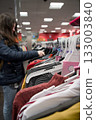 Young woman browsing clothes on a rack 133003840