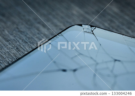 A close-up view of a cracked smartphone screen. High quality photo A close-up view of a cracked smartphone screen. High quality photo 133004246