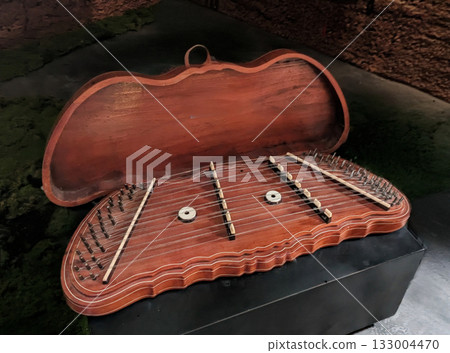 The traditional Turkish and Middle Eastern instrument "Santur" with its complex string structure and wooden case 133004470