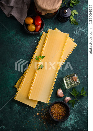 Uncooked lasagna pasta with cooking ingredient 133004935