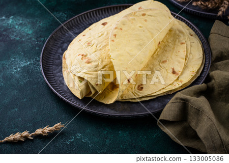 Lavash flat bread on green background Lavash flat bread on green background 133005086