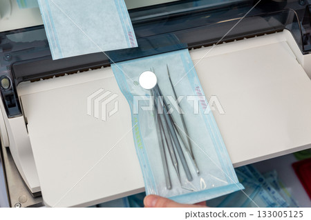 A medical professional uses a constant heat sealing machine 133005125