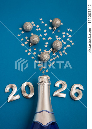 New Year 2026 Champagne Celebration with Silver Confetti on Blue Background 133005242