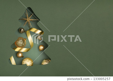 Christmas Tree Cutout Filled with Golden Ornaments on Green Background 133005257