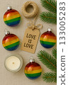 Festive Christmas Pride Flat Lay with Rainbow Ornaments, Pinecones, and Candles 133005283