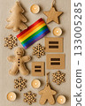 Festive Christmas Pride Flat Lay with Rainbow Ornaments, Pinecones, and Candles 133005285