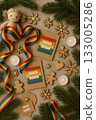 Festive Christmas Pride Flat Lay with Rainbow Ornaments, Pinecones, and Candles 133005286