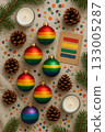 Festive Christmas Pride Flat Lay with Rainbow Ornaments, Pinecones, and Candles 133005287