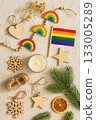 Festive Christmas Pride Flat Lay with Rainbow Ornaments, Pinecones, and Candles 133005289
