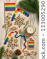 Festive Christmas Pride Flat Lay with Rainbow Ornaments, Pinecones, and Candles 133005290