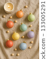Festive Christmas Pride Flat Lay with Rainbow Ornaments, Pinecones, and Candles 133005291