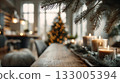 Cozy modern home interior with candles, Christmas tree, and warm bokeh lights 133005394
