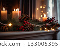 Festive candles, pinecones, and garland on decorated mantel 133005395