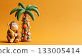 Clay monkey and palm tree with ornaments on orange background 133005414