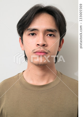 Portrait of handsome Young Asian Thai man against white background Portrait of handsome Young Asian Thai man against white background 133005569