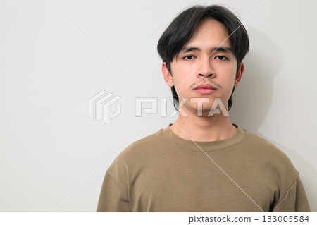 Portrait of handsome Young Asian Thai man against white background Portrait of handsome Young Asian Thai man against white background 133005584