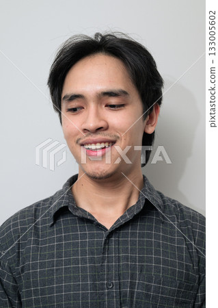 Portrait of handsome Young Asian Thai man against white background Portrait of handsome Young Asian Thai man against white background 133005602