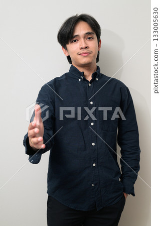 Portrait of handsome Young Asian Thai man offering handshake against white background 133005630