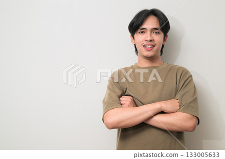 Portrait of handsome Young Asian Thai man with arms crossed against white background Portrait of handsome Young Asian Thai man with arms crossed against white background 133005633