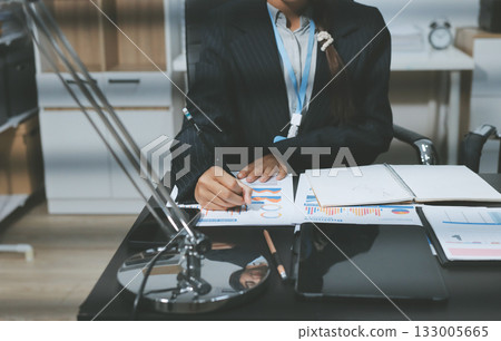 Close up high angle Asian businesswoman working with her coworker in meeting room 133005665
