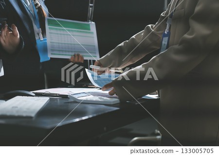 Close up high angle Asian businesswoman working with her coworker in meeting room Close up high angle Asian businesswoman working with her coworker in meeting room 133005705