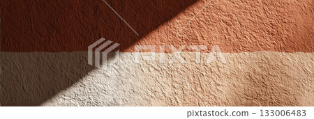 Textured clay wall with rough surface and natural color gradient in warm earth tones 133006483
