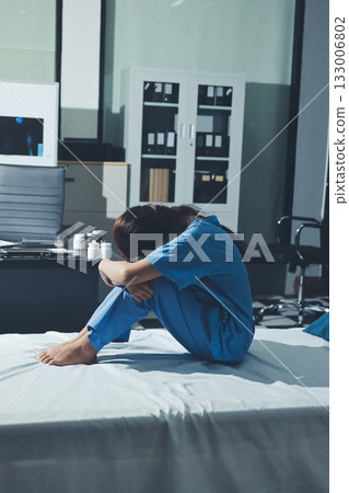 A patient with depression looks outside. A patient with depression looks outside. 133006802
