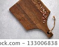 brown wooden cutting board and coarse pink salt on a gray stone table. 133006838