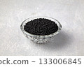 Nigela sativa black cumin in a crystal bowl on a gray concrete table. 133006845