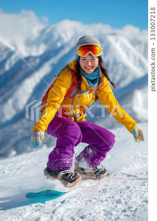 A cute woman with a dazzling smile having fun on the slopes 133007218