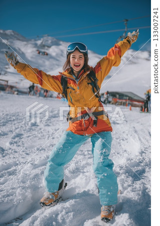 A cute woman with a dazzling smile having fun on the slopes 133007241