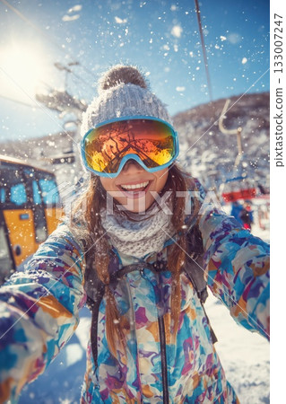 A cute woman with a dazzling smile having fun on the slopes 133007247