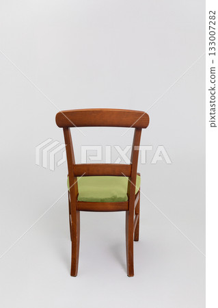 Stylish Wooden Chair featuring a comfortable Green Cushion for a cozy home aesthetic decor 133007282