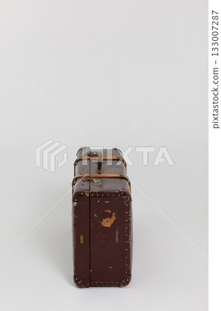 This is a Vintage Stylish Brown Leather Suitcase featuring Straps for secure closure and use 133007287