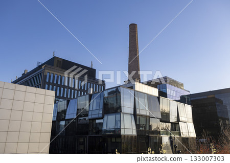 A business center with original glass architecture and industrial elements such as a pipe A business center with original glass architecture and industrial elements such as a pipe 133007303