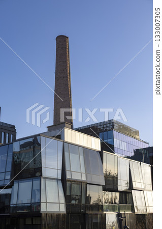 A business center with original glass architecture and industrial elements such as a pipe A business center with original glass architecture and industrial elements such as a pipe 133007305