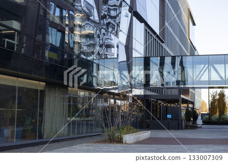 A modern business center with a glass facade and contemporary architecture A modern business center with a glass facade and contemporary architecture 133007309