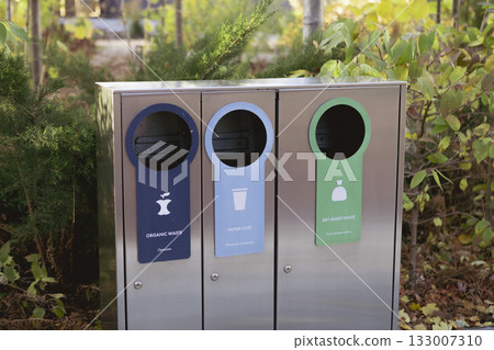 Modern glossy metal trash can. Waste sorting. Green concept. Modern glossy metal trash can. Waste sorting. Green concept. 133007310