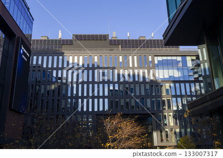 A modern business center with a glass facade and contemporary architecture A modern business center with a glass facade and contemporary architecture 133007317