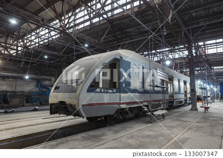 An electric train at a train construction and repair plant 133007347